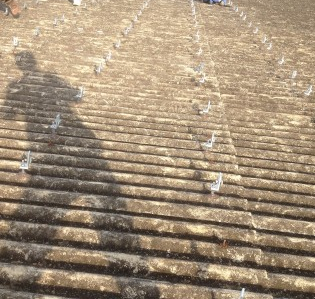 This is a corrugated asbestos roof showing signs of age