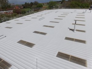 Industrial roof waterproofing system applied to large commercial building with rooflights